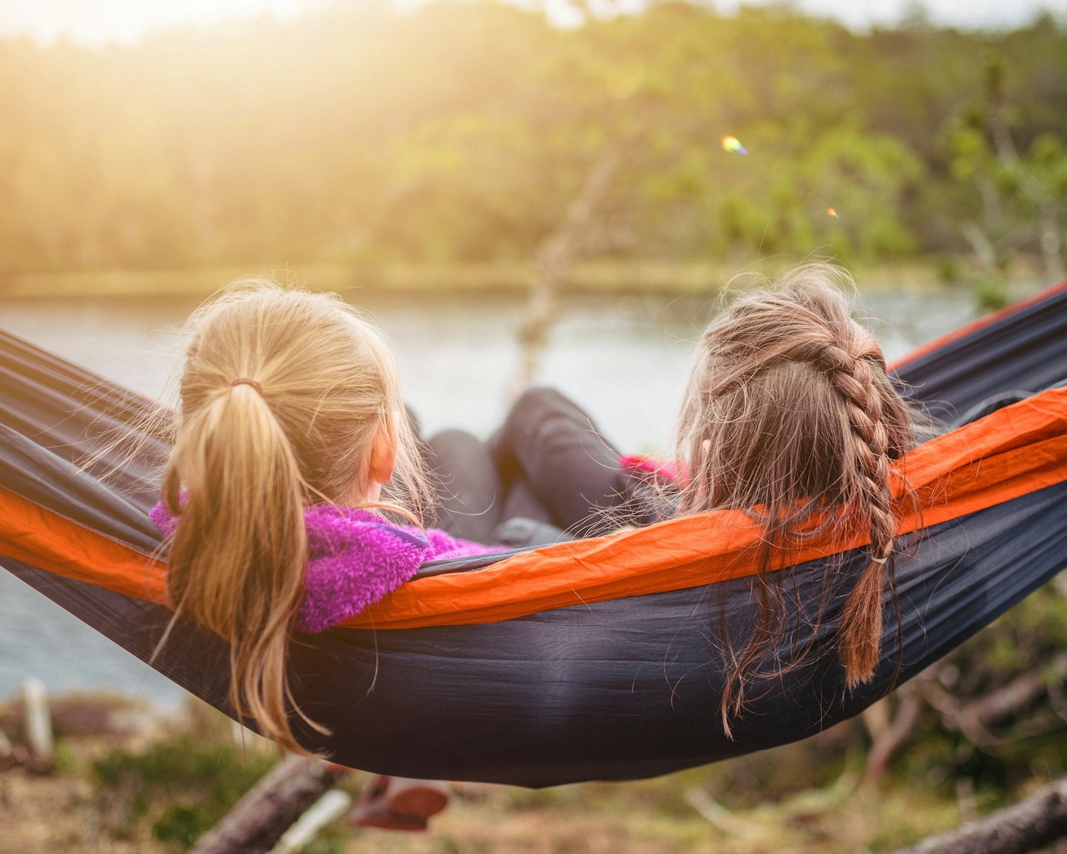 Family camping with children beside a tent at a safe, organized campsite