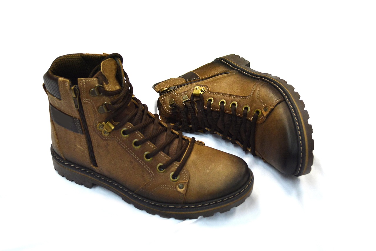 Pair of combat-style boots being used for hiking on rugged outdoor terrain