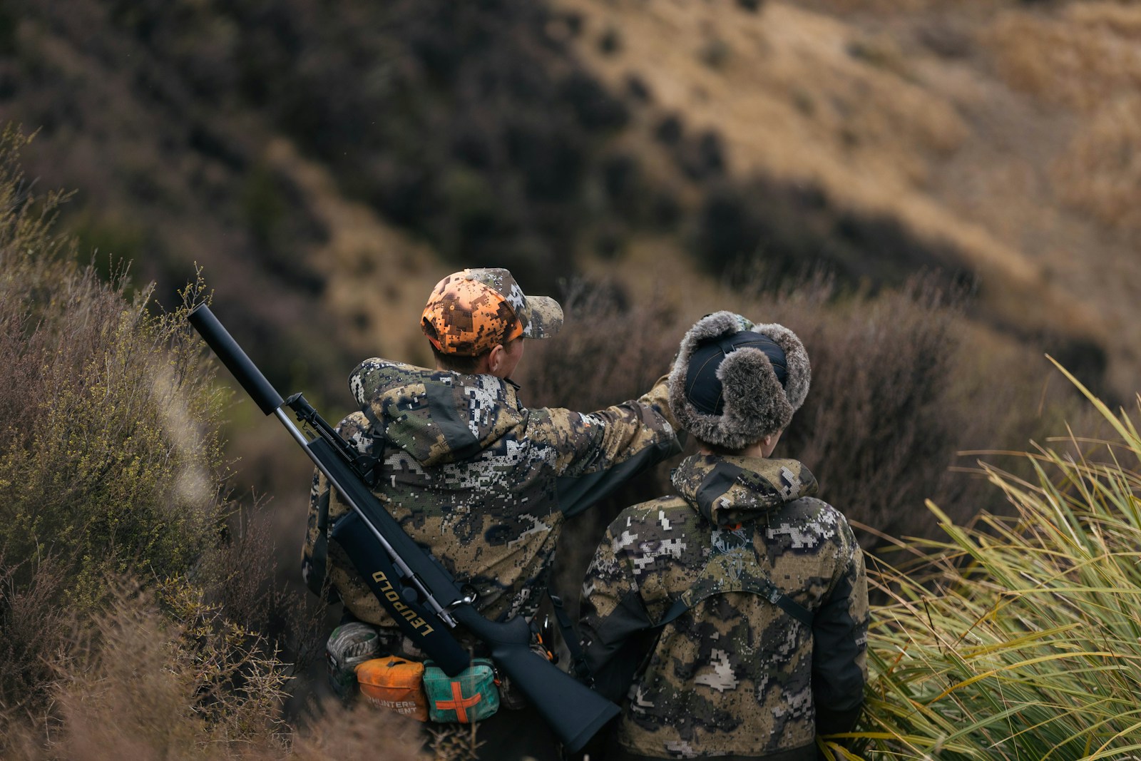 Hunter reviewing current state hunting regulations and season rules before a hunt