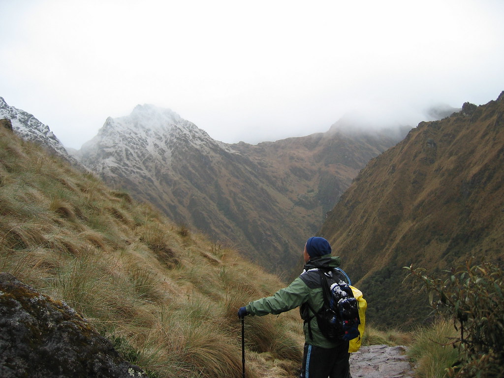 Hiker wearing a fitted backpack on a mountain trail
