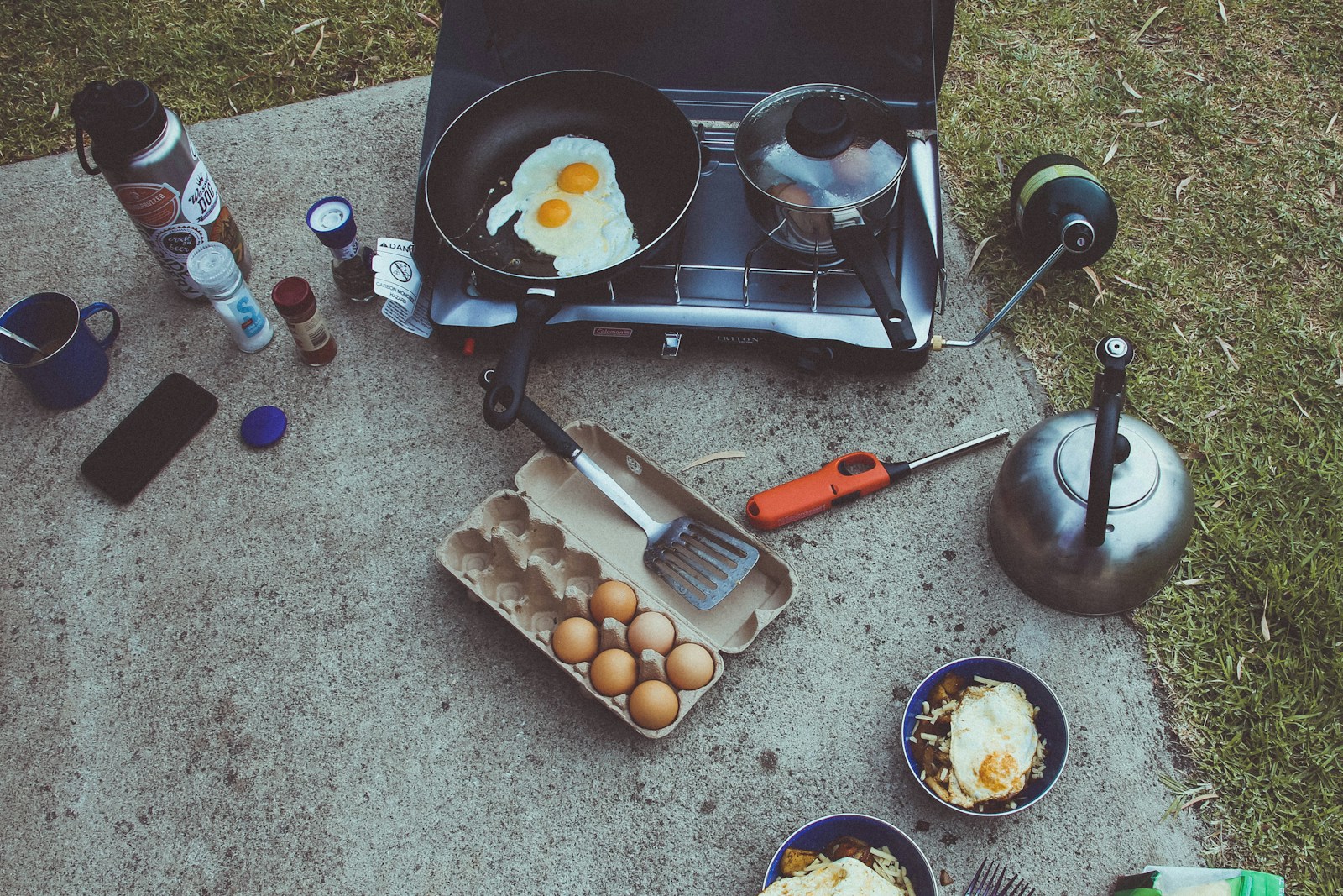 Eggs secured in a rigid camping carrier beside ice in a food cooler