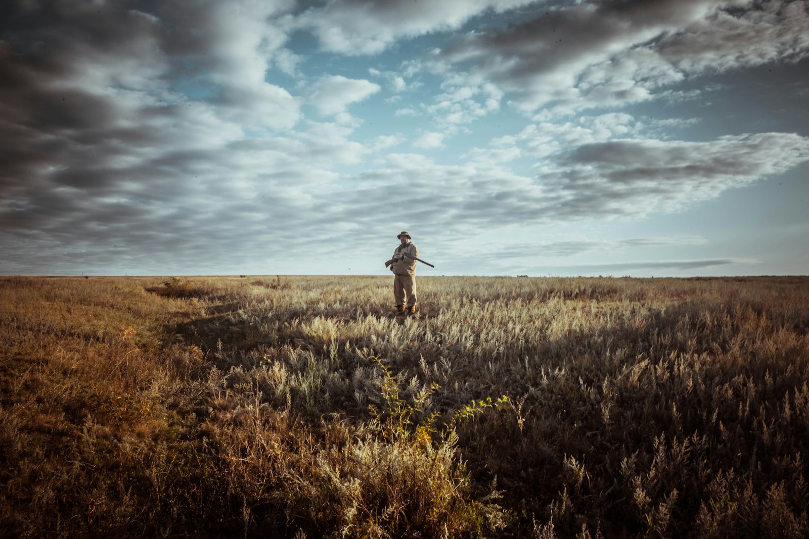 Hunter observing wildlife habitat while participating in responsible conservation and land stewardship