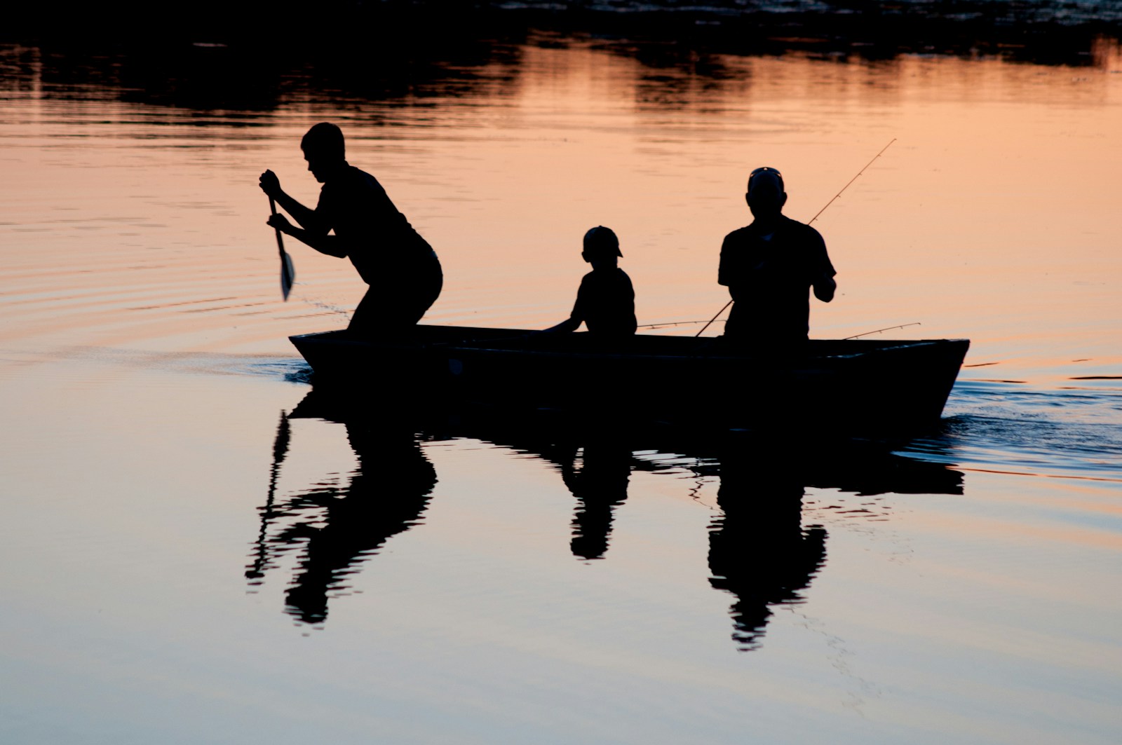 Angler studying shoreline structure and water conditions to find a fishing spot
