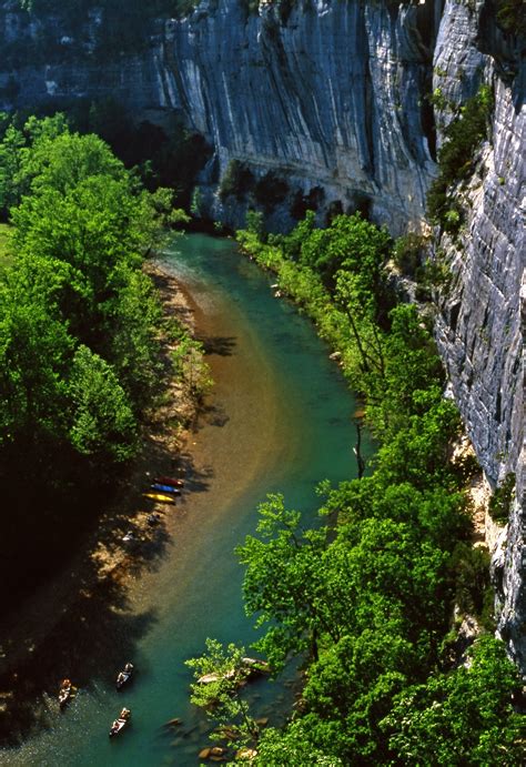 Tent camping beside the Buffalo National River beneath forested Ozark bluffs in Arkansas