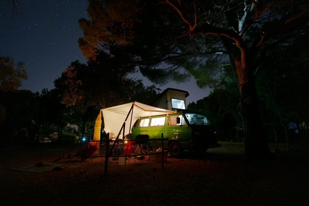 CPAP machine beside a portable battery power station inside a dry campsite setup