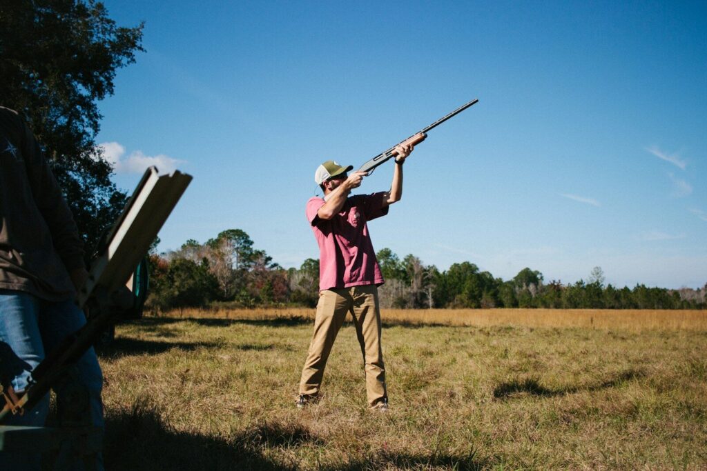Outdoor worker checking wildlife habitat and field gear during a hunting-industry workday