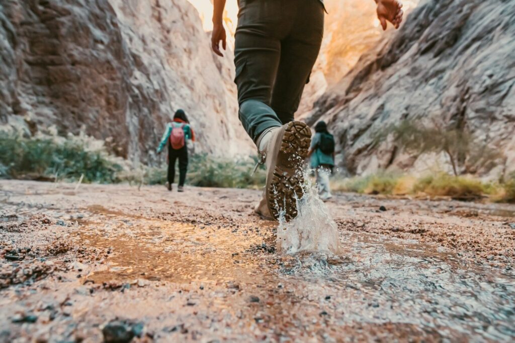 Hiker jogging on a dirt trail while wearing low-cut hiking shoes