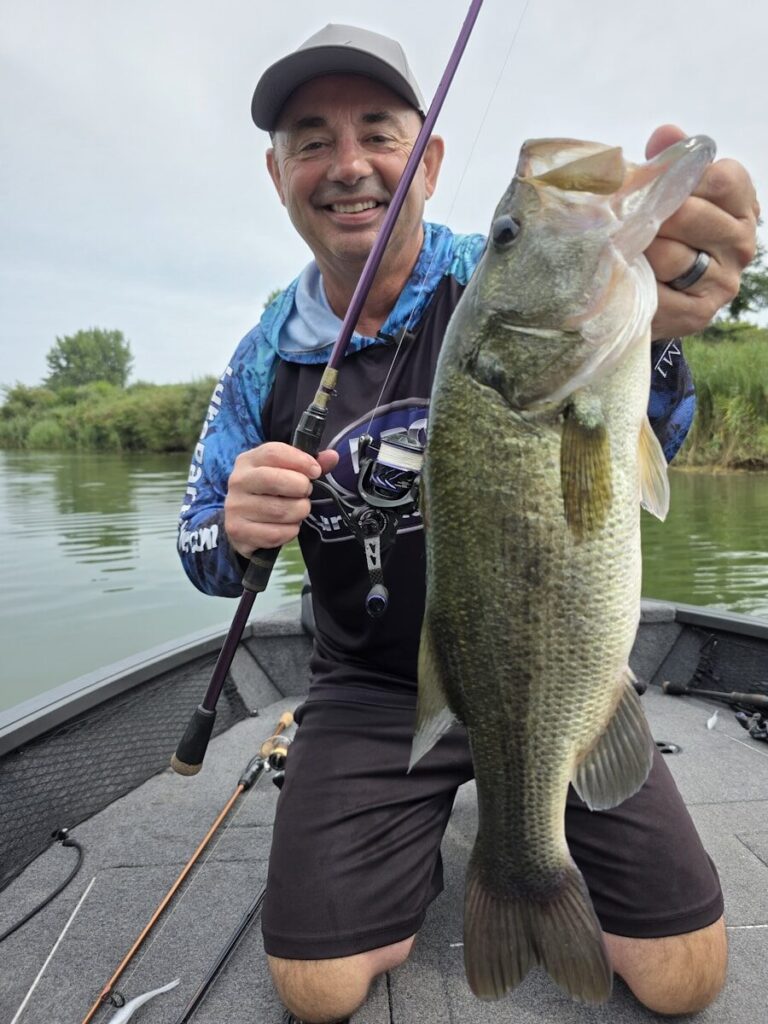 Bass angler using forward-facing sonar electronics while fishing from a boat