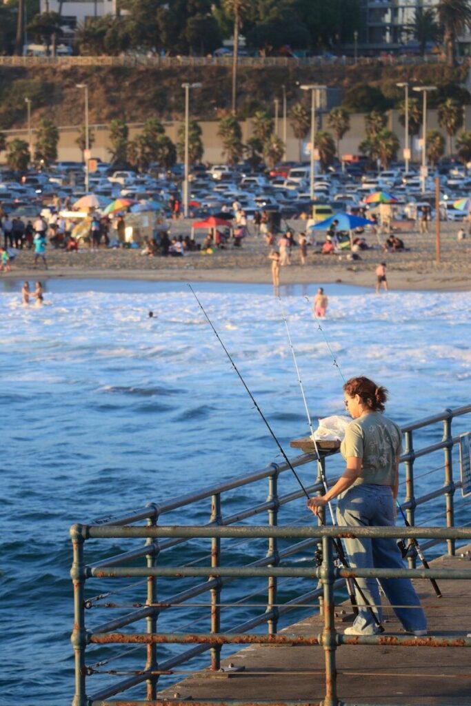 Angler fishing California waters during a summer morning with mountain and coastal fishing opportunities