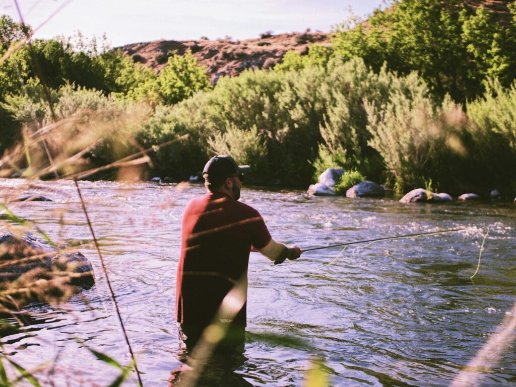 Angler fishing a clear Idaho mountain river during summer
