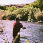 Angler fishing a clear Idaho mountain river during summer