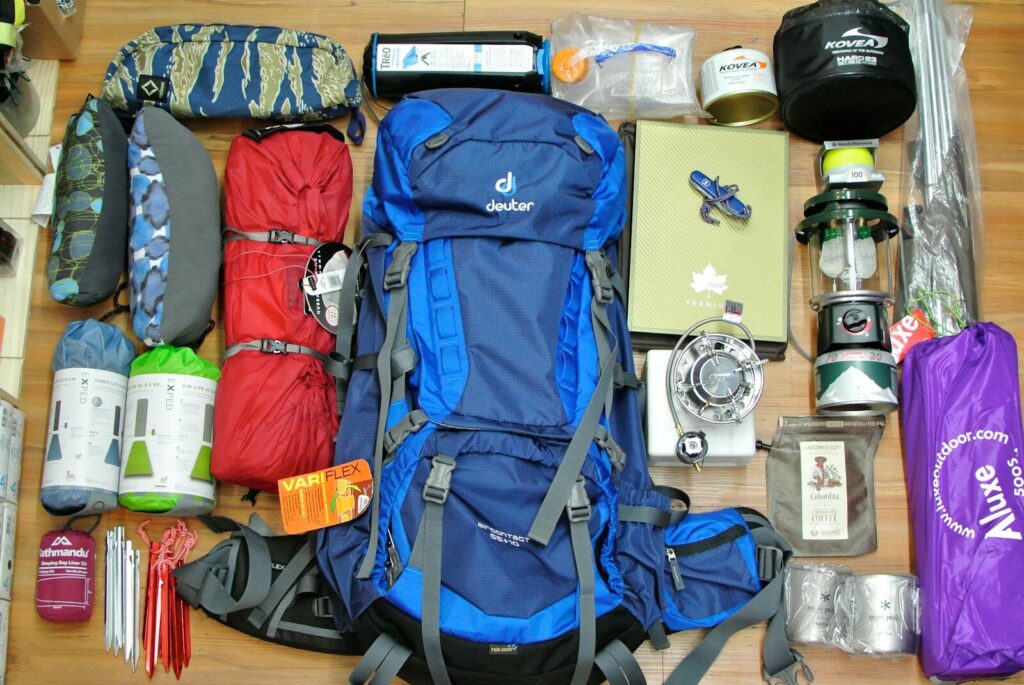 Clean used tents backpacks sleeping bags and camping gear organized for donation