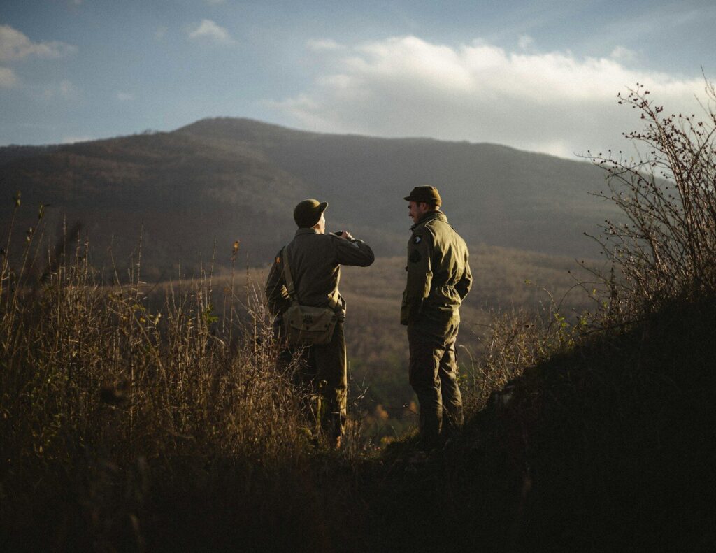 Hunting guide leading clients safely through rugged outdoor terrain during a guided hunt