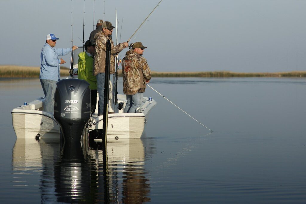 Fishing guide preparing rods and tackle beside a boat before taking clients onto the water