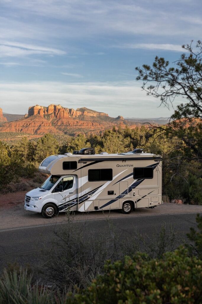 RV buyer inspecting a travel trailer at a large dealership before signing paperwork