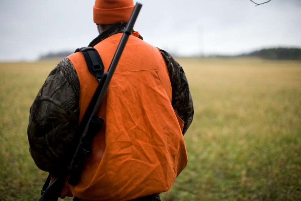Beginner deer hunter preparing in the field with safe, ethical hunting practices in mind